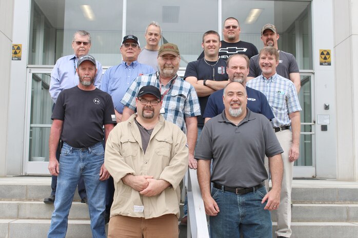 Several AEDC team members at Arnold Air Force Base who worked at Micro Craft in Tullahoma during the heyday of the NASA X-43A program, come together for a photo April 25 at Arnold. The X-43A was part of the larger NASA Hyper-X program, which later led to the development of the Boeing X-51 WaveRider, a longer-flying, jet-fueled hypersonic aircraft. Pictured starting in back row from left are: Ronnie Long, Casey Crawford and Paul Sullivan; third row: John Nichols, Dale McKill, Bradley Rogers and Troy Bisby; second row: Derrick Burton, Don Thompson and Jeff Fulks; and in front: Barry Puckett and Bob Williams. Not pictured are: Tim Scott, Don Wilt, Mike Mashburn, Kim Vanzant and Earl Vanzant. (U.S. Air Force photo by Deidre Ortiz)