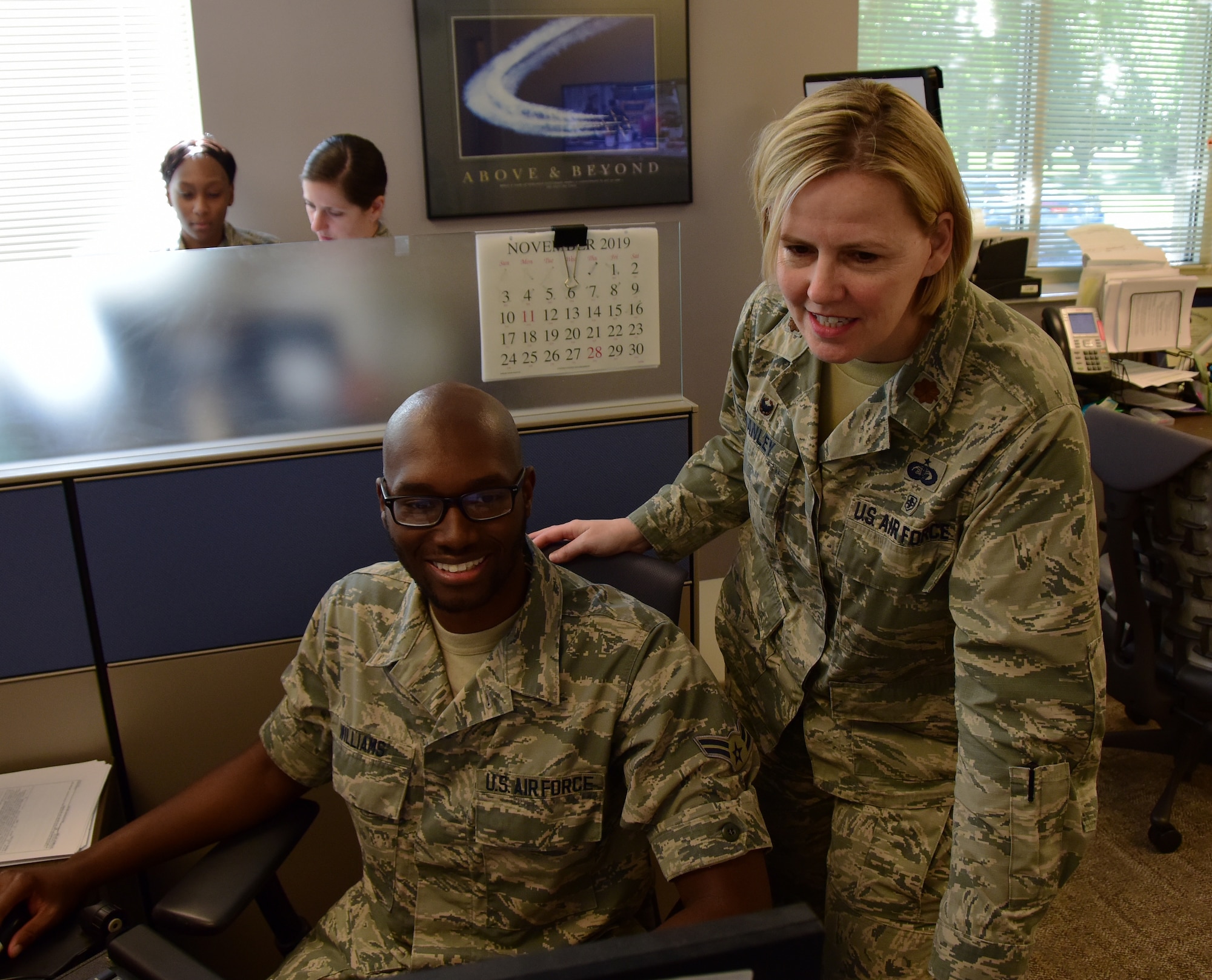 U.S. Air Force Maj. Melissa Danley, commander of the 118th Force Support Squadron, Tennessee Air National Guard, examines the work of Airman 1st Class Willie Williams, a personnelist with the 118th FSS, May 14, 2019 at Berry Field Air National Guard Base, Nashville, Tennessee.