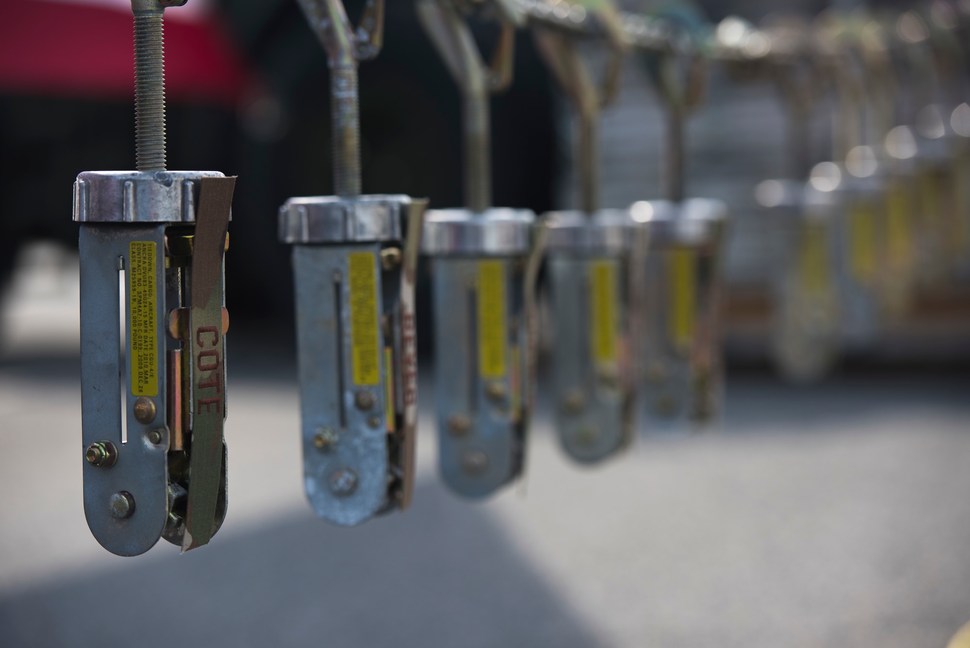 Tie-downs hang from a chain.