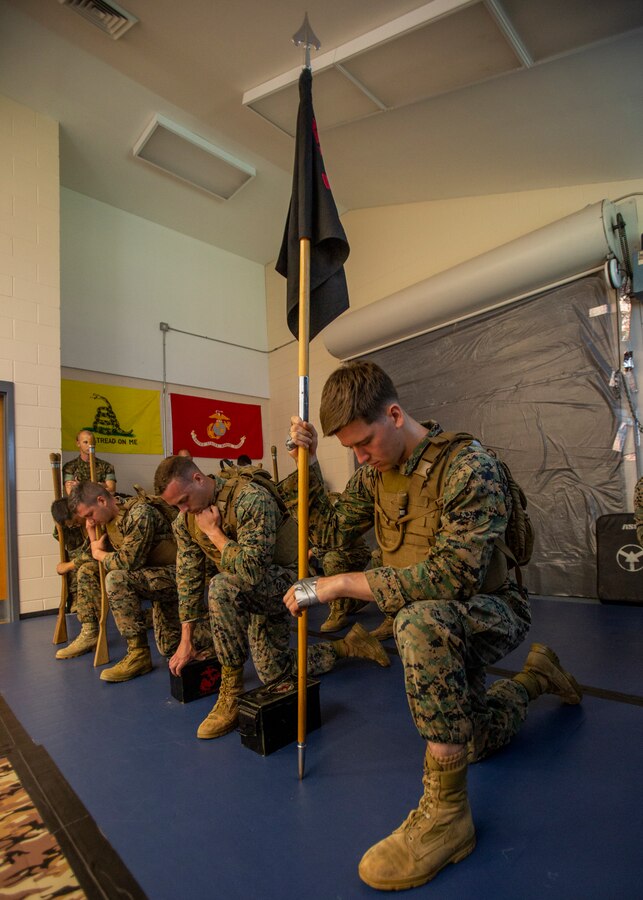 U.S. Marines with Martial Arts Instructor Course 1-19 listen to a motivational speech before a 3-mile run at Naval Air Station Joint Reserve Base New Orleans on May 15, 2019. To increase readiness and to support the total force, Reserve and active Marines with Marine Forces Reserve participate in the MAI Course.  (U.S. Marine Corps photo by Lance Cpl. Jose Gonzalez)