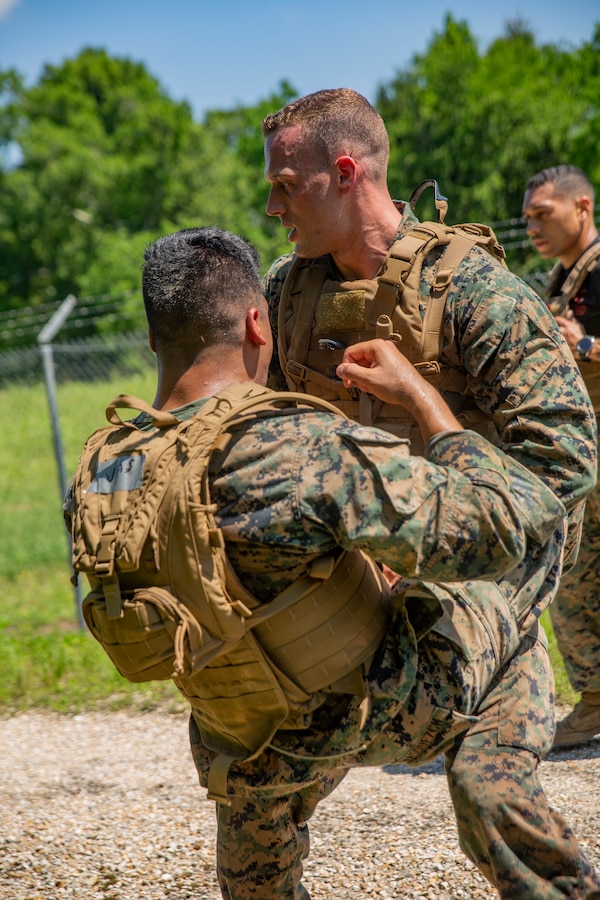 U.S. Marines with Martial Arts Instructor Course 1-19 conduct buddy crunches during a 3-mile run at Naval Air Station Joint Reserve Base New Orleans on May 15, 2019. To increase readiness and to support the total force, Reserve and active Marines with Marine Forces Reserve participate in the MAI Course.  (U.S. Marine Corps photo by Lance Cpl. Jose Gonzalez)