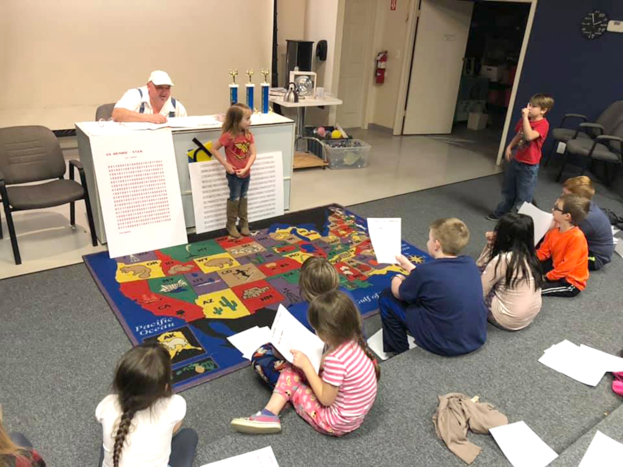 Chuck Mangino, left, one of the special guests during the Spring Camp at the Hands-On Science Center, teaches the campers the significance of Pi and gives them some tips on how to work on their memorization skills. (Courtesy photo)