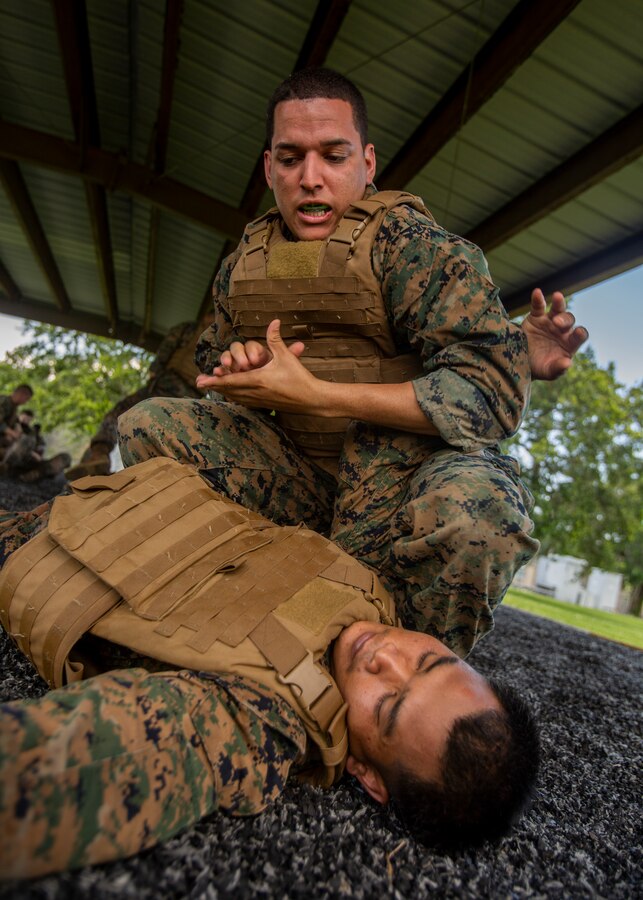 U.S. Marine Corps Cpl. Luis Alicea, right, a ground support equipment mechanic with Marine Aircraft Group 49, 4th Marine Aircraft Wing, Marine Forces Reserve, performs a counter to the mount technique at Naval Air Station Joint Reserve Base New Orleans on May 15, 2019. The students performed Marine Corps Martial Arts Program techniques before a gray belt evaluation test. To increase readiness and to support the total force, Reserve and active Marines with MARFORRES participate in the Martial Arts Instructor Course. (U.S. Marine Corps photo by Lance Cpl. Jose Gonzalez)