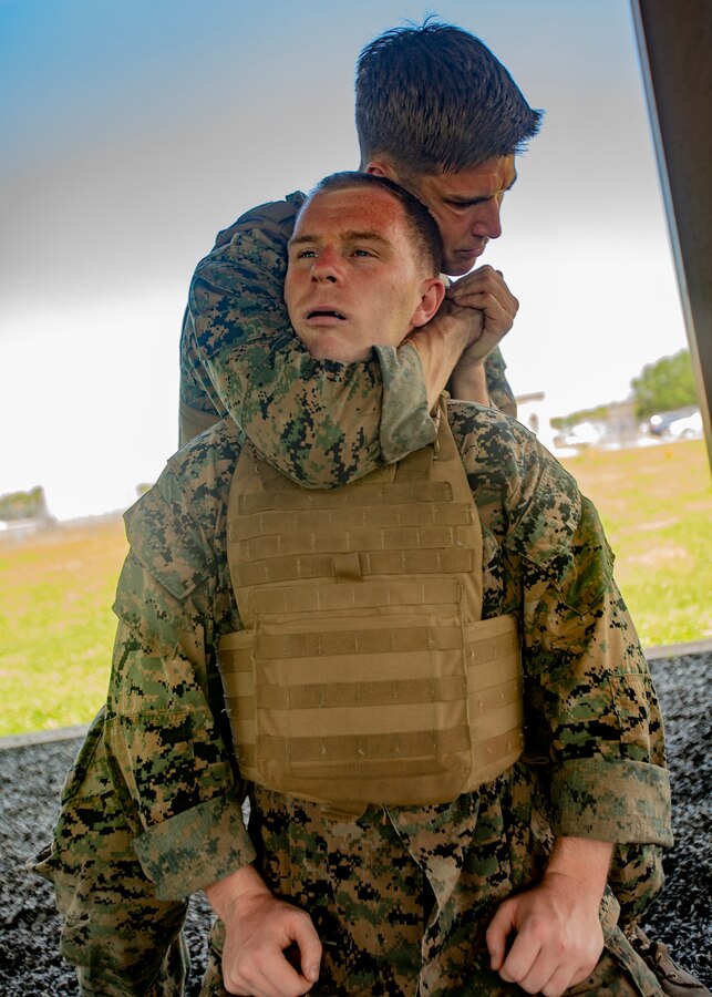 U.S. Marine Corps Cpl. Logan Harris, right, an airframes mechanic with Marine Aircraft Group 49, 4th Marine Aircraft Wing, Marine Forces Reserve, performs a rear choke technique at Naval Air Station Joint Reserve Base New Orleans on May 15, 2019. The students performed Marine Corps Martial Arts Program techniques before a gray belt evaluation test. To increase readiness and to support the total force, Reserve and active Marines with MARFORRES participate in the Martial Arts Instructor Course.  (U.S. Marine Corps photo by Lance Cpl. Jose Gonzalez)