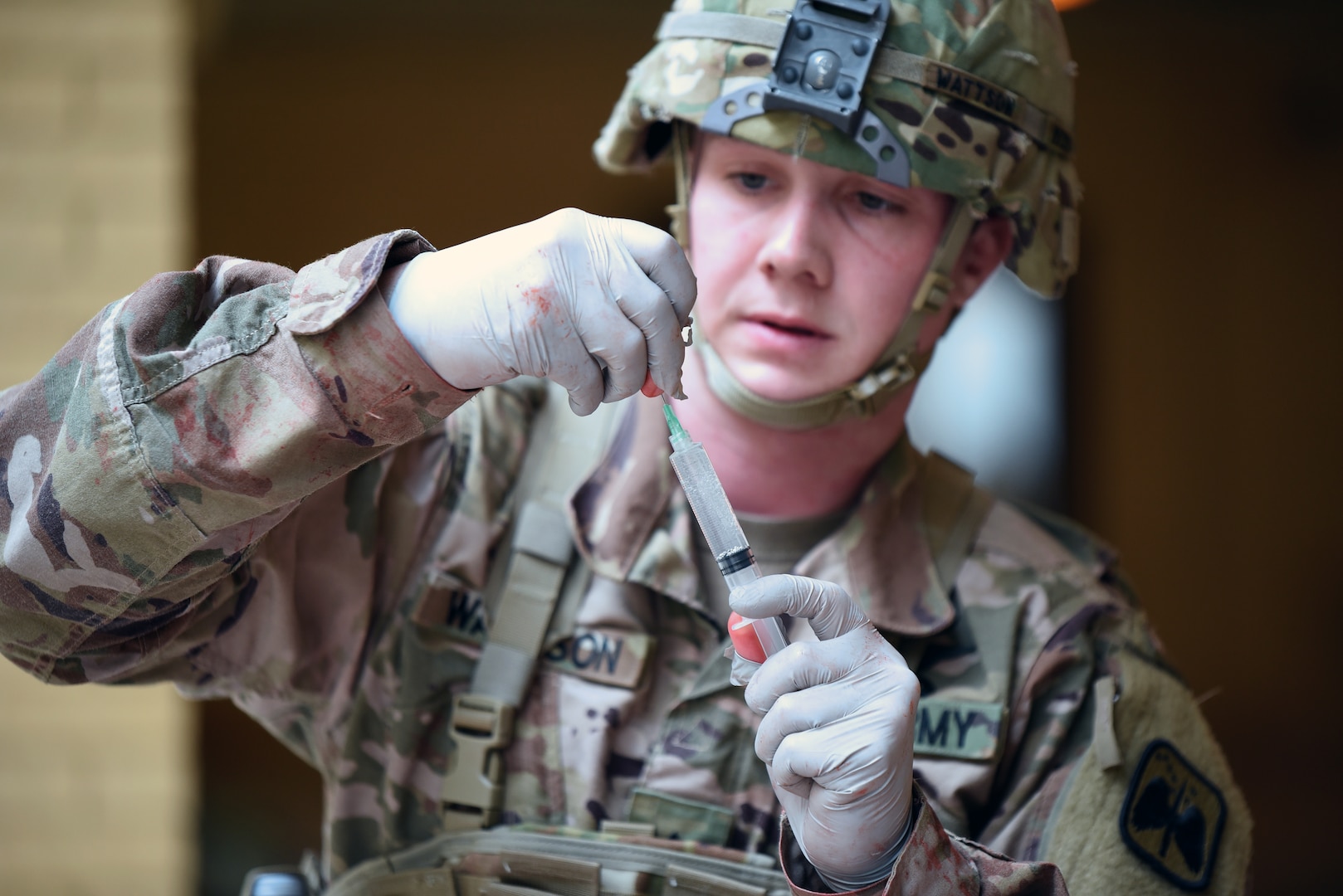 A 68W Combat Medic attending the Army Medical Department Center & School, Health Readiness Center of Excellence Noncommissioned Officers Academy Advanced Leader Course prepares an injection.