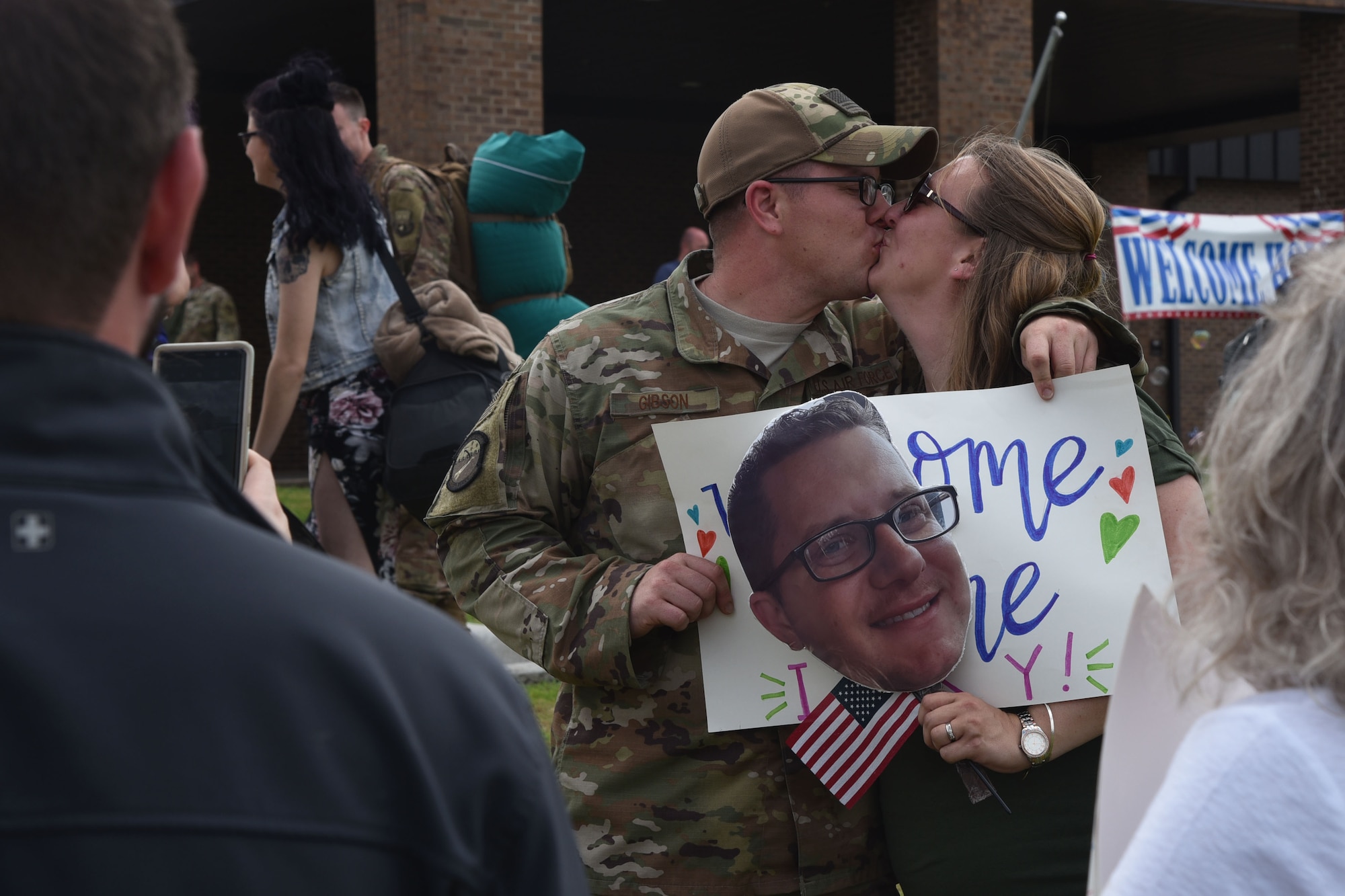 U.S. Air Force Reserve Tech. Sgt. Richard Gibson, 913th Maintenance Squadron crew chief, kisses his wife after returning from deployment at Little Rock Air Force Base, Arkansas, May 19, 2019.
