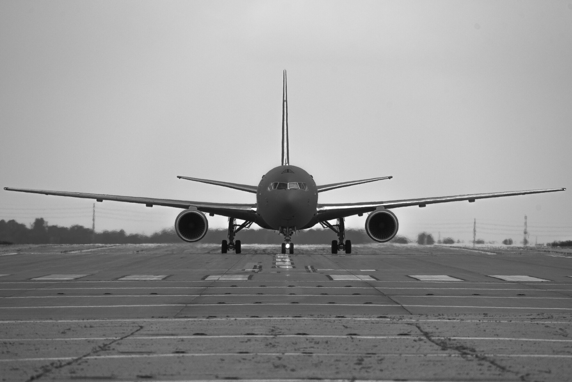 A KC-46A Pegasus lands May 17, 2019, at McConnell Air Force Base, Kan.  This KC-46 is Team McConnell’s sixth delivery, and it will join a fleet that will advance air refueling capabilities around the world. (U.S. Air Force photo illustration by Airman 1st Class Alexi Myrick)