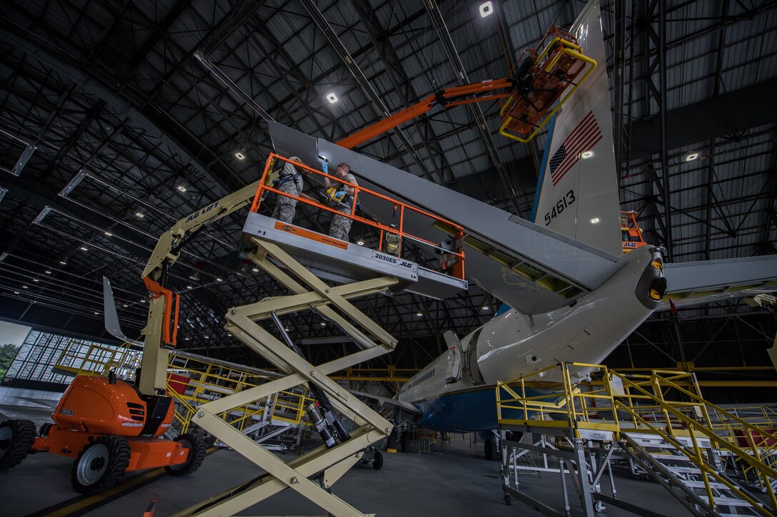 Staff Sgt. Brandon Simmons, lubricating rudder and Airman 1st Class Derek Wise, providing additional light, both crew chiefs with 932nd Maintenance Squadron, work on a C-40C during routine checks May 15, 2019, Scott Air Force Base, Illinois. (U.S. Air Force photo by Christopher Parr)