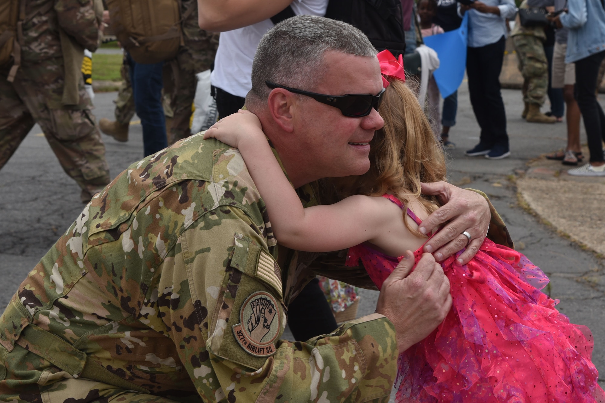 U.S. Air Force Reserve Lt. Col. Chris Dickens, 327th Airlift Squadron chief pilot, hugs his daughter after returning from deployment at Little Rock Air Force Base, Arkansas, May 19, 2019.