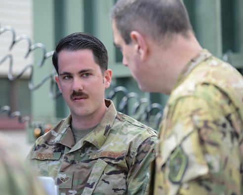 U.S. Air Force Senior Airman Josh Pedigo, 86th Vehicle Readiness Squadron vehicle operator, speaks with Brig. Gen. Mark R. August, 86th Airlift Wing commander on Ramstein Air Base, Germany, May 17, 2019.