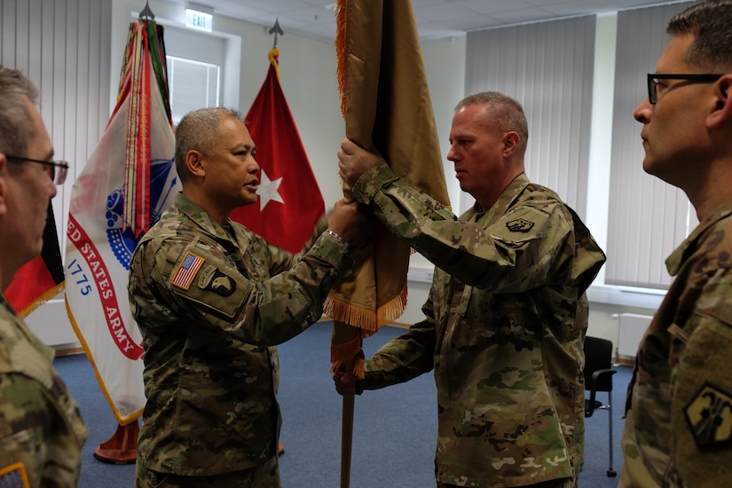 Col. Alexis M. Wells (left) outgoing commander of the 510th Regional Support Group, 7th Mission Support Command hands over the unit´s guidon to Brig. Gen. Fred R. Maiocco, commander of the 7th MSC during a change of command ceremony held at U.S. Army Garrison Rheinland-Pfalz, Sembach May 19, 2019. (US Army photo by Sgt. Daniel J. Friedberg, 7th MSC Public Affairs Office).