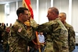 Col. Aaron J. Justice (left) commander of the 510th Regional Support Group, 7th Mission Support Command accepts the unit´s guidon from Brig. Gen. Fred R. Maiocco, commander of the 7th MSC during a change of command ceremony held at United States Army Garrison Rheinland-Pfalz, Sembach May 19, 2019. (US Army photo by Sgt. Daniel J. Friedberg, 7th MSC Public Affairs Office).