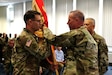 Col. Alexis M. Wells (left) outgoing commander of the 510th Regional Support Group, 7th Mission Support Command hands over the unit´s guidon to Brig. Gen. Fred R. Maiocco, commander of the 7th MSC during a change of command ceremony held at U.S. Army Garrison Rheinland-Pfalz, Sembach May 19, 2019. (US Army photo by Sgt. Daniel J. Friedberg, 7th MSC Public Affairs Office).