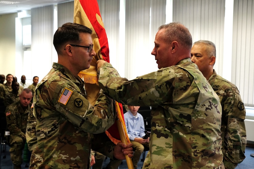Col. Aaron J. Justice (left) commander of the 510th Regional Support Group, 7th Mission Support Command accepts the unit´s guidon from Brig. Gen. Fred R. Maiocco, commander of the 7th MSC during a change of command ceremony held at United States Army Garrison Rheinland-Pfalz, Sembach May 19, 2019. (US Army photo by Sgt. Daniel J. Friedberg, 7th MSC Public Affairs Office).