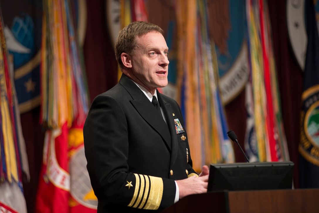 ADM Michael Rogers, USN, addresses the audience and the CYBERCOM, NSA, and CSS workforces at his Assumption of Command ceremony, 03 April 2014