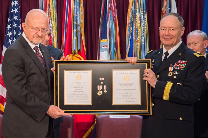 Director for National Intelligence James Clapper awards GEN Keith Alexander, USA, the National Intelligence Distinguished Service Medal on Alexander's retirement, March 28, 2014