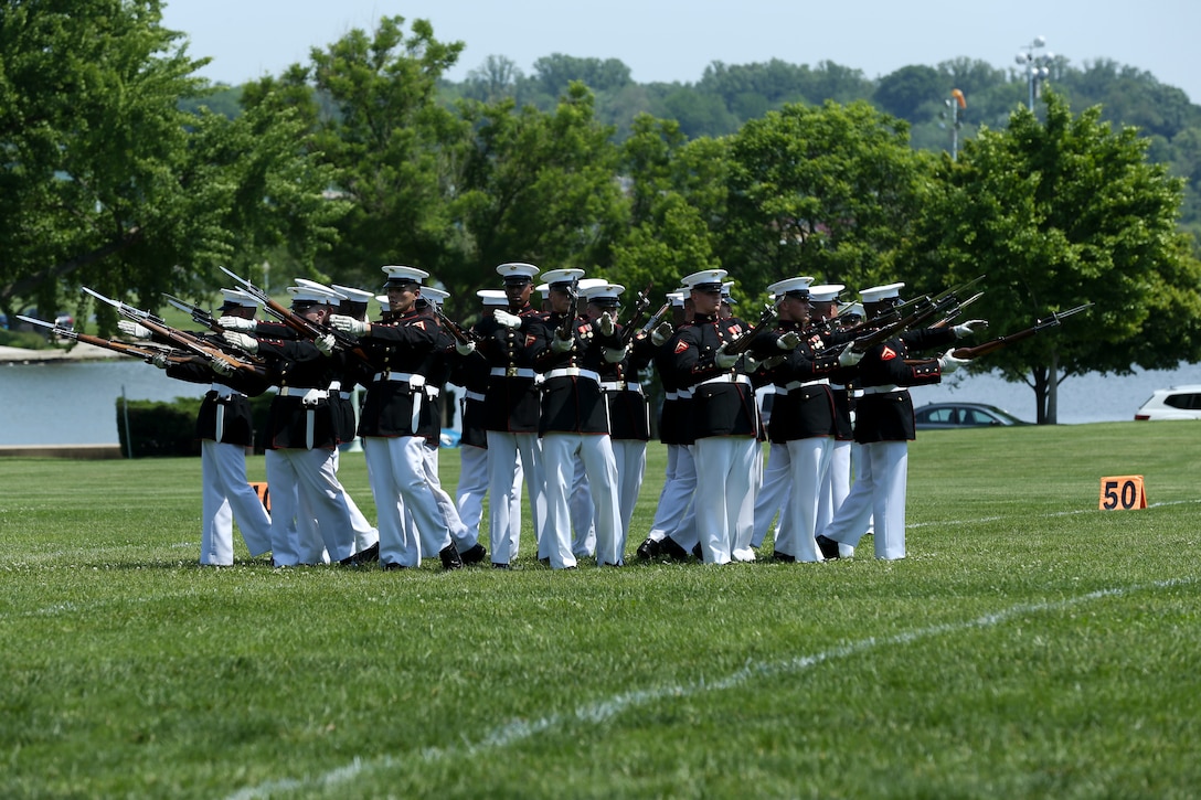 Marines with the U.S. Marine Corps Silent Drill Platoon, Marine Barracks Washington D.C., execute their “Bursting Bomb” sequence during a Battle Color Ceremony at the United States Naval Academy in Annapolis, Maryland, May 20, 2019. Parents, family members and guests of the First Class Midshipmen were invited to attend a series of events, in honor of the graduates. (U.S. Marine Corps photo by Pfc. Allen Sanders)