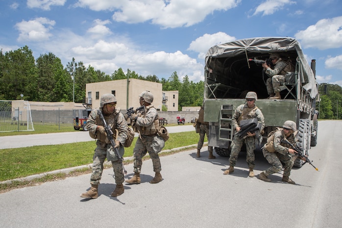 U.S. Marines with Combat Logistics Battalion 8, Combat Logistics Regiment 2, 2nd Marine Logistics Group, provide security around a medium tactical vehicle replacement during a training exercise at Camp Lejeune, N.C., May 16, 2019. CLB 8 held the exercise to train Marines in core mission tasks and provide company-level convoy operations training. (U.S. Marine Corps photo by Cpl. Damion Hatch)