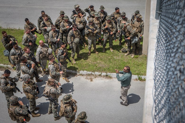 George Frick, a counter-improvised explosive device instructor with Marine Corps Engineer School, Training Command, briefs Marines during a training exercise at Camp Lejeune, N.C., May 16, 2019. Combat Logistics Battalion 8 held the exercise to train Marines in core mission tasks and provide company-level convoy operations training. (U.S. Marine Corps photo by Cpl. Damion Hatch)