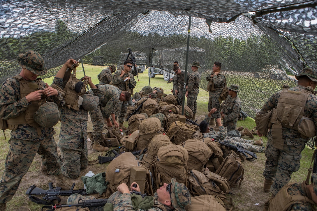 U.S. Marines with Combat Logistics Battalion 8, Combat Logistics Regiment 2, 2nd Marine Logistics Group, put on gear during a training exercise at Camp Lejeune, N.C., May 16, 2019. CLB 8 held the exercise to train Marines in core mission tasks and provide company-level convoy operations training. (U.S. Marine Corps photo by Cpl. Damion Hatch)
