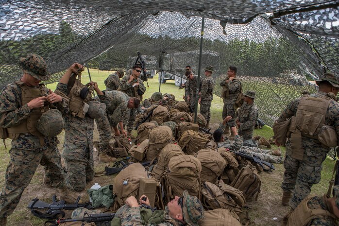 U.S. Marines with Combat Logistics Battalion 8, Combat Logistics Regiment 2, 2nd Marine Logistics Group, put on gear during a training exercise at Camp Lejeune, N.C., May 16, 2019. CLB 8 held the exercise to train Marines in core mission tasks and provide company-level convoy operations training. (U.S. Marine Corps photo by Cpl. Damion Hatch)