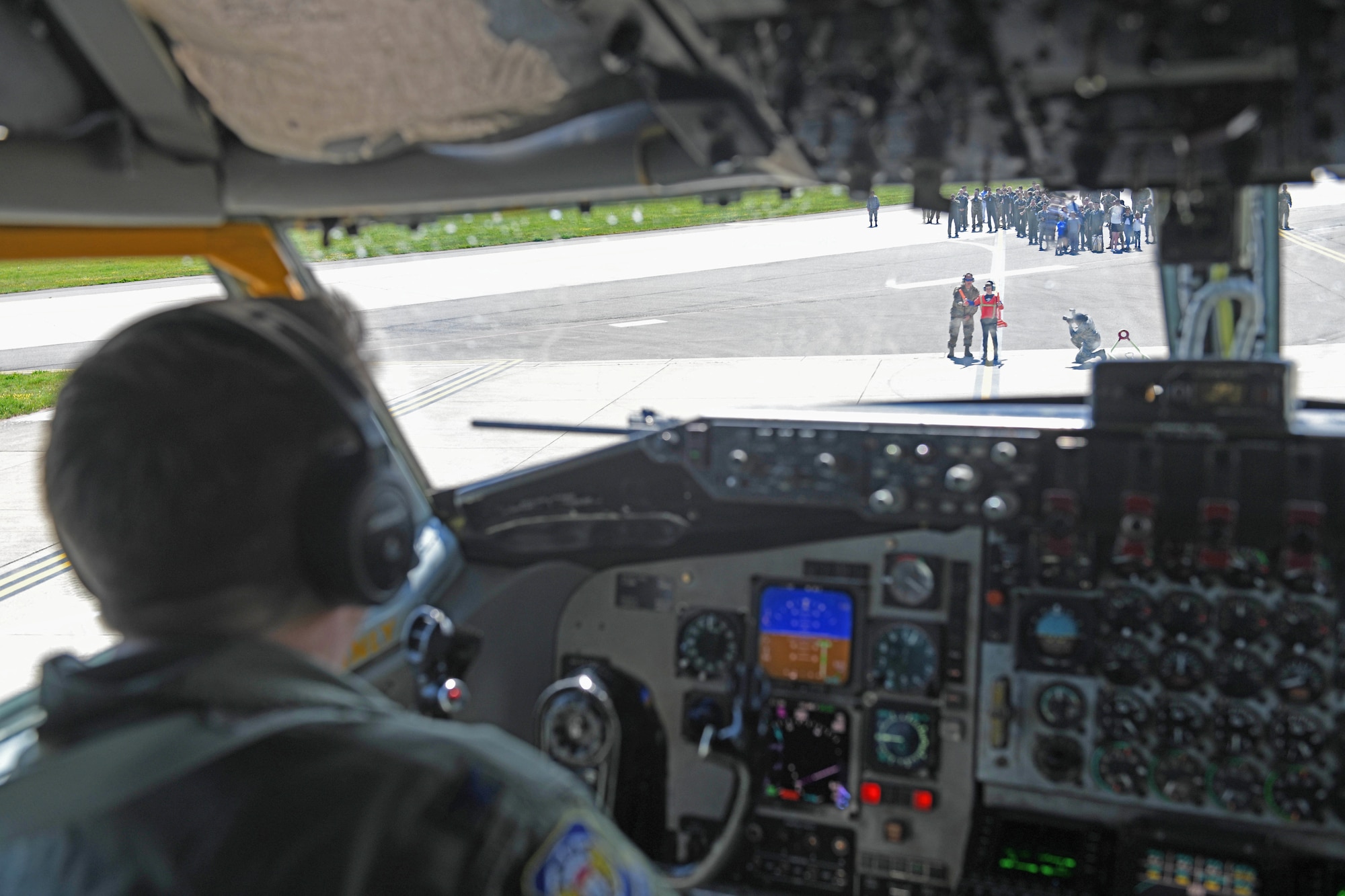 U.S. Air Force Col. Christopher Amrhein, 100th Air Refueling Wing commander, is marshalled in by his son while he pilots a KC-135 Stratotanker during his “fini flight” at RAF Mildenhall, England, May 15, 2019. Amrhein celebrated the end of his two-year command of the Bloody Hundredth by flying a KC-135 from RAF Mildenhall one last time. (U.S. Air Force photo by Senior Airman Luke Milano)