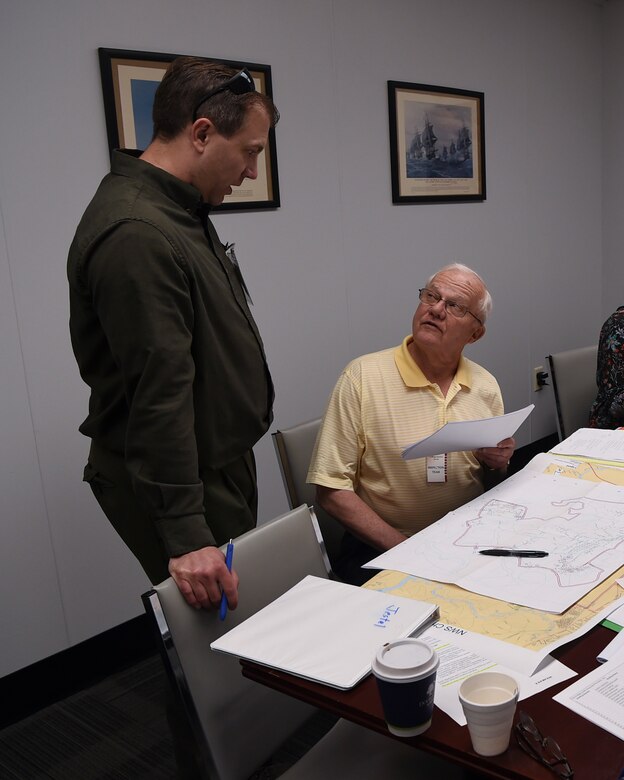Alex Jestel (left) and Mac Williams (right), both Naval Treaty Implementation Program compliance inspectors working on the Chemical Weapons Convention exercise, discuss potential locations to be inspected May 15, 2019, at Naval Weapons Station Charleston, Joint Base Charleston, S.C. A feature of the Convention is its incorporation of the “challenge inspection,” whereby any State Party in doubt about another State Party’s compliance can request a surprise inspection. The purpose of the exercise is to test the response of base assistance teams should the U.S. receive an international challenge inspection under the Chemical Weapons Convention Treaty. The Chemical Weapons Convention aims to eliminate an entire category of weapons of mass destruction by prohibiting the development, production, acquisition, stockpiling, retention, transfer or use of chemical weapons by States Parties. Exercises like these support the Department of Defense’s priority of reformation and full spectrum readiness in the face of new challenges. (U.S. Air Force photo by Senior Airman Cody R. Miller)