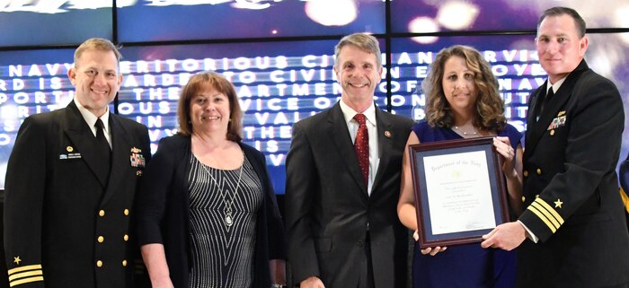 IMAGE: Lori Buckwalter receives the Navy Meritorious Civilian Service award during the annual honorary awards ceremony, May 10. Standing left to right: NSWCDD Dam Neck Activity Commanding Officer Cmdr. Andrew Hoffman; NSWCDD Deputy Technical Director Angela Beach; U.S. Rep. Rob Wittman; Buckwalter; and NSWCDD Commanding Officer Cmdr. Stephen ‘Casey’ Plew.