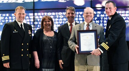 IMAGE: Larry Wilkerson receives the Navy Meritorious Civilian Service award during the annual honorary awards ceremony, May 10. Standing left to right: NSWCDD Dam Neck Activity Commanding Officer Cmdr. Andrew Hoffman; NSWCDD Deputy Technical Director Angela Beach; U.S. Rep. Rob Wittman; Wilkerson; and NSWCDD Commanding Officer Cmdr. Stephen ‘Casey’ Plew.