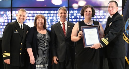 IMAGE: Christina Gruszecki receives the Navy Meritorious Civilian Service award during the annual honorary awards ceremony, May 10. Standing left to right: NSWCDD Dam Neck Activity Commanding Officer Cmdr. Andrew Hoffman; NSWCDD Deputy Technical Director Angela Beach; U.S. Rep. Rob Wittman; Gruszecki; and NSWCDD Commanding Officer Cmdr. Stephen ‘Casey’ Plew.