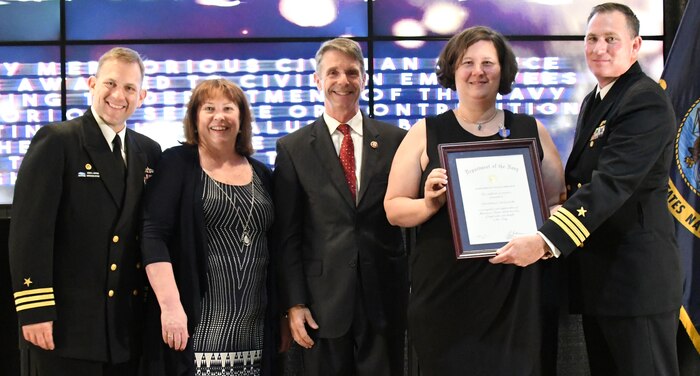 IMAGE: Christina Gruszecki receives the Navy Meritorious Civilian Service award during the annual honorary awards ceremony, May 10. Standing left to right: NSWCDD Dam Neck Activity Commanding Officer Cmdr. Andrew Hoffman; NSWCDD Deputy Technical Director Angela Beach; U.S. Rep. Rob Wittman; Gruszecki; and NSWCDD Commanding Officer Cmdr. Stephen ‘Casey’ Plew.