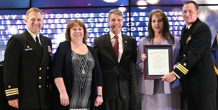 IMAGE: Melissa Lederer receives the Navy Meritorious Civilian Service award during the annual honorary awards ceremony, May 10. Standing left to right: NSWCDD Dam Neck Activity Commanding Officer Cmdr. Andrew Hoffman; NSWCDD Deputy Technical Director Angela Beach; U.S. Rep. Rob Wittman; Lederer; and NSWCDD Commanding Officer Cmdr. Stephen ‘Casey’ Plew.