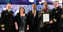 IMAGE: Steven Anderson receives the Navy Meritorious Civilian Service award during the annual honorary awards ceremony, May 10. Standing left to right: NSWCDD Dam Neck Activity Commanding Officer Cmdr. Andrew Hoffman; NSWCDD Deputy Technical Director Angela Beach; U.S. Rep. Rob Wittman; Anderson; and NSWCDD Commanding Officer Cmdr. Stephen ‘Casey’ Plew.