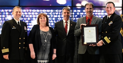 IMAGE: Steven Anderson receives the Navy Meritorious Civilian Service award during the annual honorary awards ceremony, May 10. Standing left to right: NSWCDD Dam Neck Activity Commanding Officer Cmdr. Andrew Hoffman; NSWCDD Deputy Technical Director Angela Beach; U.S. Rep. Rob Wittman; Anderson; and NSWCDD Commanding Officer Cmdr. Stephen ‘Casey’ Plew.