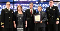 IMAGE: Joshua Rudolph receives the Leadership Award during the annual honorary awards ceremony, May 10. Standing left to right: NSWCDD Dam Neck Activity Commanding Officer Cmdr. Andrew Hoffman; NSWCDD Deputy Technical Director Angela Beach; U.S. Rep. Rob Wittman; Rudolph; and NSWCDD Commanding Officer Cmdr. Stephen ‘Casey’ Plew.
