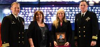 IMAGE: Stacy Palivoda-Estes receives the Award of Excellence for  Systems Engineering and Integration at the annual honorary awards ceremony, May 10.  Standing left to right: NSWCDD Dam Neck Activity Commanding Officer Cmdr. Andrew Hoffman; NSWCDD Deputy Technical Director Angela Beach; Palivoda-Estes; and NSWCDD Commanding Officer Cmdr. Stephen ‘Casey’ Plew.