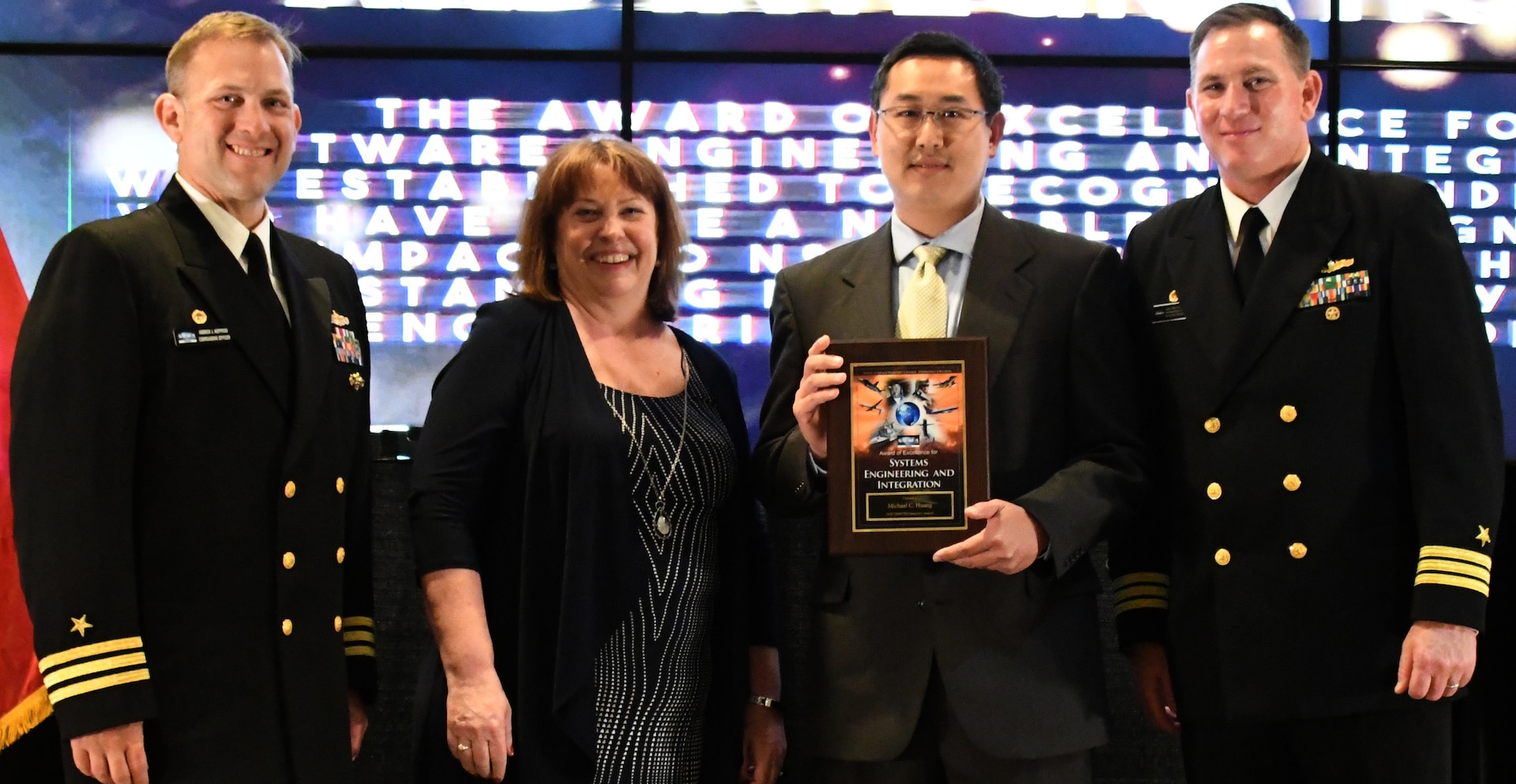 IMAGE: Michael Huang receives the Award of Excellence for  Systems Engineering and Integration at the annual honorary awards ceremony, May 10.  Standing left to right: NSWCDD Dam Neck Activity Commanding Officer Cmdr. Andrew Hoffman; NSWCDD Deputy Technical Director Angela Beach; Huang; and NSWCDD Commanding Officer Cmdr. Stephen ‘Casey’ Plew.