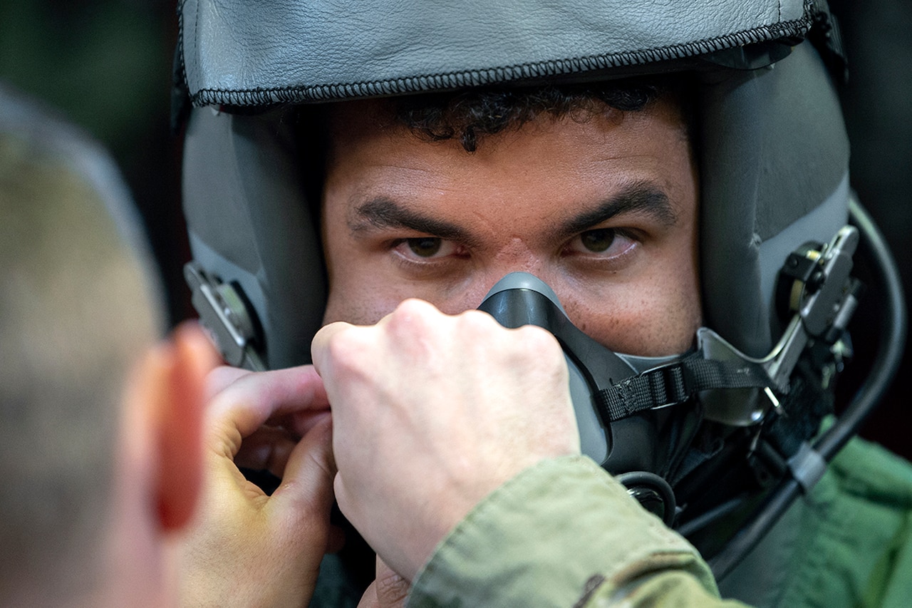 A man gets fitted with a helmet and mask.