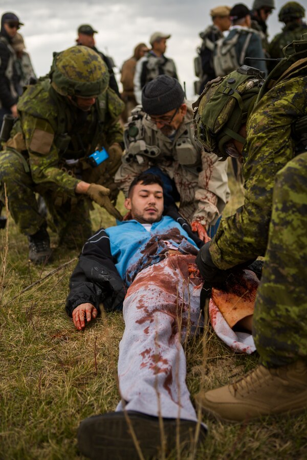 Canadian Soldiers with 1st Battalion Princess Patricia’s Canadian Light Infantry, provide medical support to a simulated civilian casualty during stability operations for exercise Maple Resolve in Camp Wainwright, Alberta, Canada, May 12, 2019. Maple Resolve is an annual exercise, 3-week multinational simulated war, hosted by the Canadian Army bringing NATO allies together from across the world to share and learn tactics while strengthening foreign military ties. (U.S. Marine Corps photo by Cpl. Niles Lee)