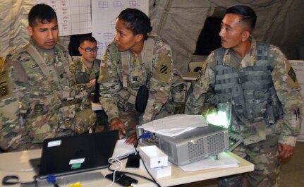 Army Medical Department Center & School, Health Readiness Center of Excellence students participate in a field training exercise for the Captains Career Course at Joint Base San Antonio-Camp Bullis May 7. From left to right are Capt. Jonatan Caballero, 3rd Cavalry Regiment medical support operations officer at Fort Hood, Texas; Capt. Romia Freeman, 3rd Combat Aviation Brigade behavioral health officer at Hunter Army Airfield, Ga.; and Chief Warrant Officer Phoutthasone Inthalangsy, Medical Education and Training Campus chief of curriculum support at Joint Base San Antonio-Fort Sam Houston. During the exercise, the students were part of a medical brigade putting together a disaster relief plan to support and help civil authorities responding to a hurricane that hit Houston. Students in the nine-week Captains Career Course learn about and undergo hands-on training on concepts, processes and skills to prepare them to lead medical units in support of ground combat operations and assisting civil authorities in emergency situations.