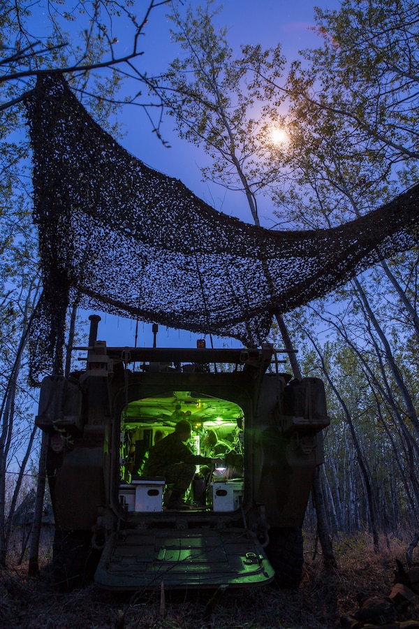The crew of a Canadian light armored vehicle from Charlie Company, 1st Battalion Princess Patricia’s Canadian Light Infantry, prepare to bed down for the night during exercise Maple Resolve in Camp Wainwright, Alberta, Canada, May 13, 2019. Maple Resolve is an annual exercise, 3-week multinational simulated war, hosted by the Canadian Army bringing NATO allies together from across the world to share and learn tactics while strengthening foreign military ties. (U.S. Marine Corps photo by Cpl. Niles Lee)