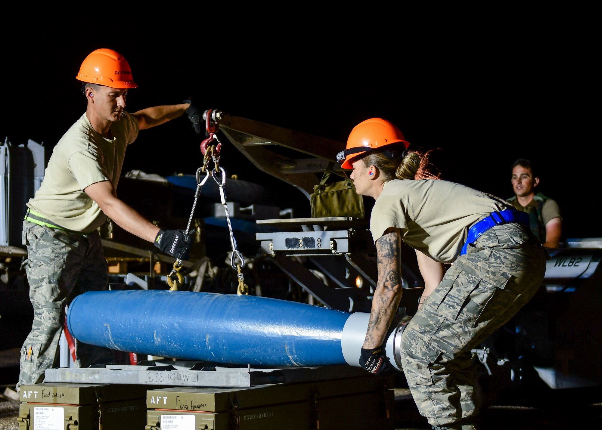 U.S. Air Force Airmen from the 355th Equipment Maintenance Squadron work together to build an [inert] GBU-12 Paveway II, an aerial laser-guided bomb, in a simulated deployed location on the flight line at Davis-Monthan Air Force Base, Ariz., April 9, 2019.