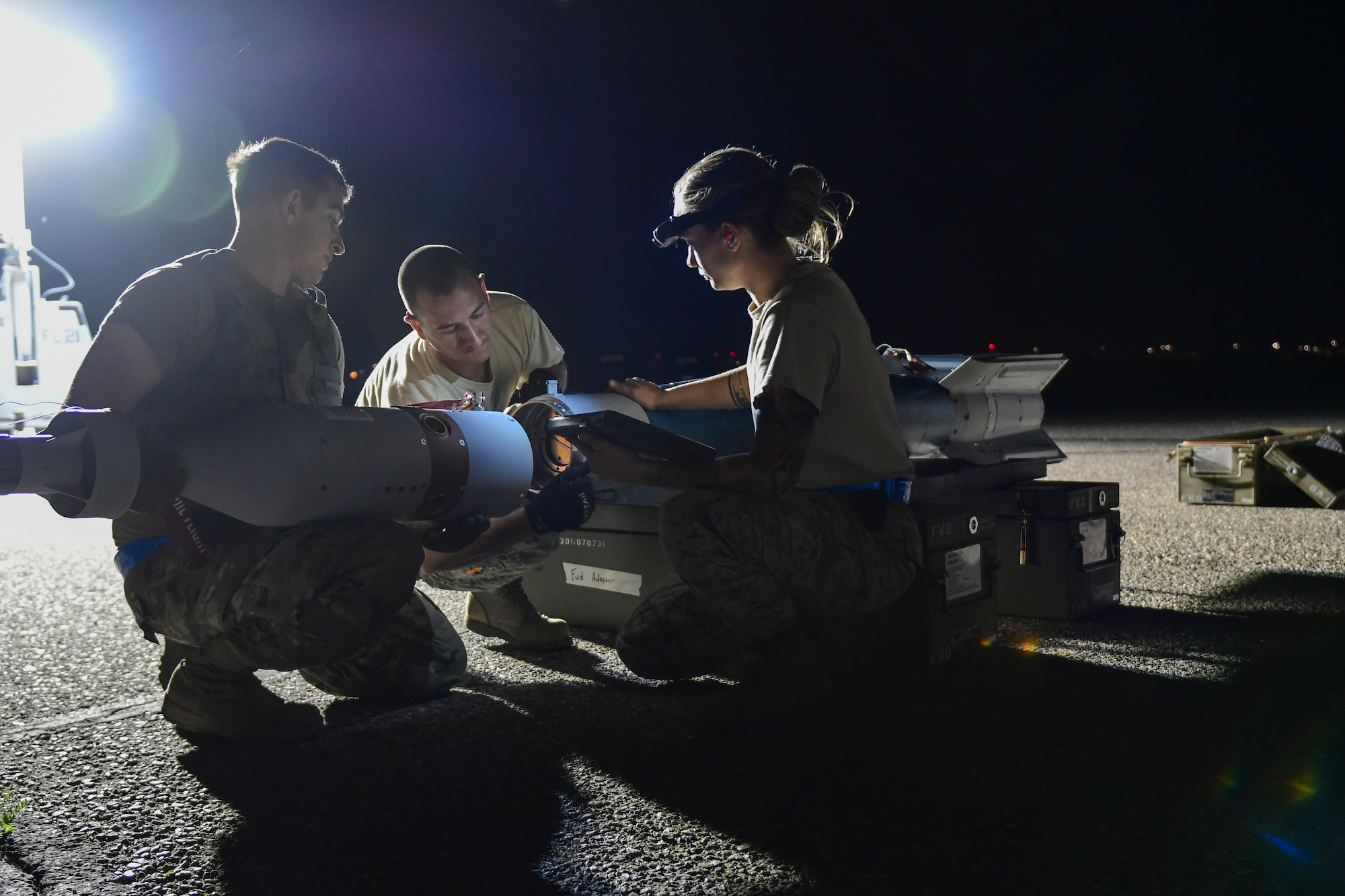 U.S. Air Force Airmen from the 355th Equipment Maintenance Squadron work together to build an [inert] GBU-12 Paveway II, an aerial laser-guided bomb, in a simulated deployed location on the flight line at Davis-Monthan Air Force Base, Ariz., April 9, 2019.