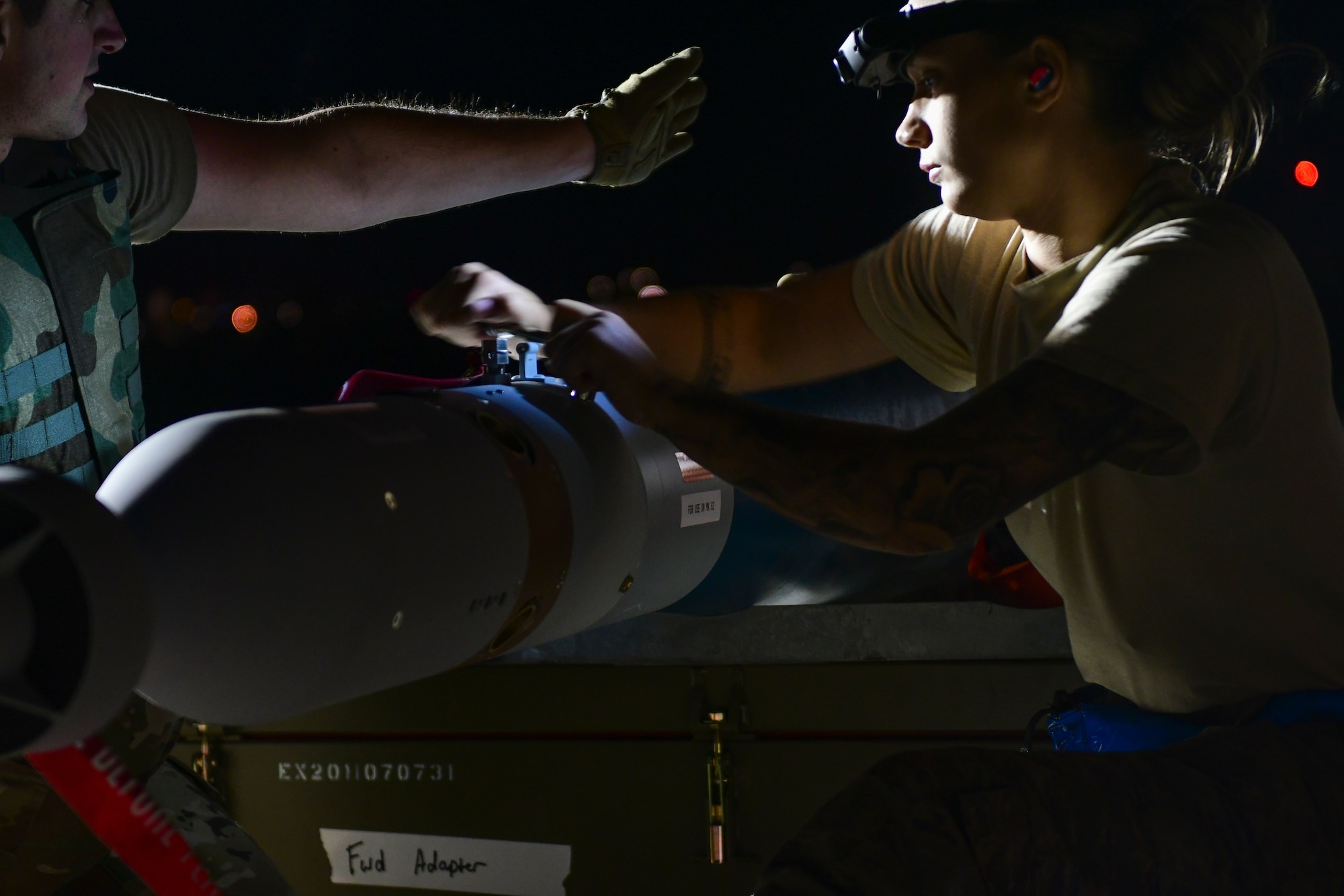 U.S. Air Force Airmen from the 355th Equipment Maintenance Squadron work together to build an [inert] GBU-12 Paveway II, an aerial laser-guided bomb, in a simulated deployed location on the flight line at Davis-Monthan Air Force Base, Ariz., April 9, 2019.