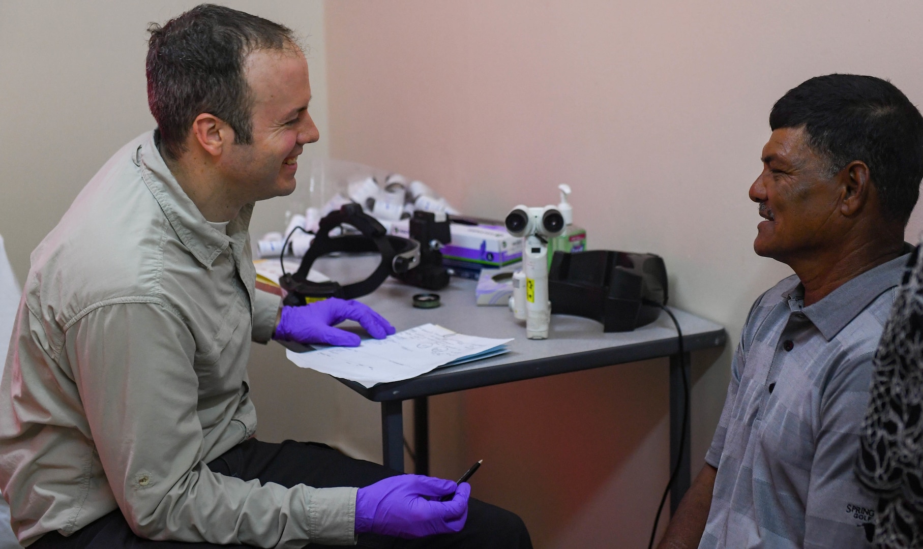 Air Force Lt. Col. James Richard Townley, ophthalmologist from Joint Base Elmendorf-Richardson, Alaska, talks with a patient during the New Horizons exercise 2019 at Port Mourant, Guyana, May 3, 2019. The New Horizons exercise 2019 provides U.S. military members an opportunity to train for an overseas deployment and the logistical requirements it entails. The exercise promotes bilateral cooperation by providing opportunities for U.S. and partner nation military engineers, medical personnel and support staff to work and train side by side.