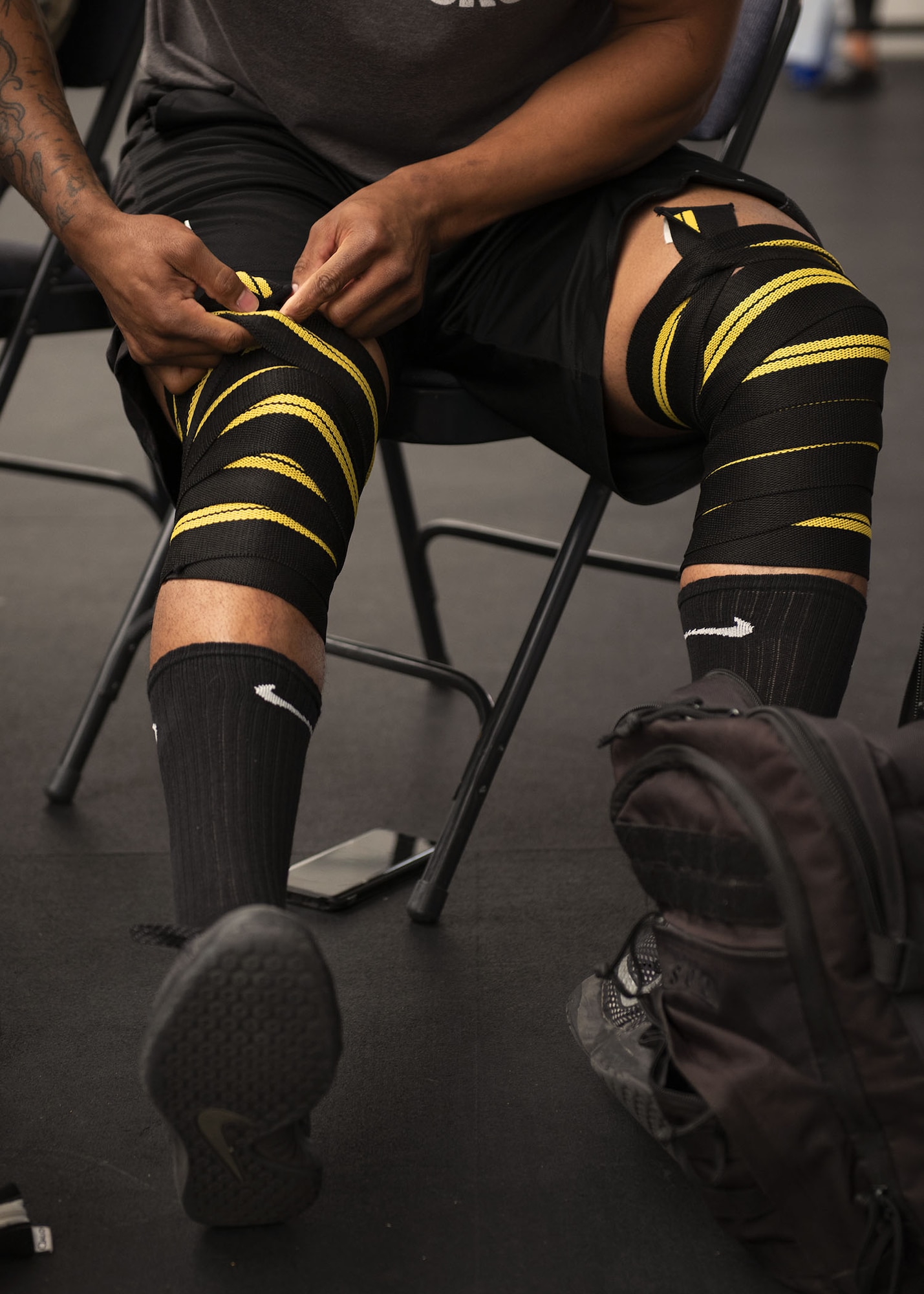 Airman 1st Class Jeremy Conway, 63rd Operation Support Squadron aircrew flight equipment member, wraps his knees with support wraps during the Luke Powerlifting Competition, May 17, 2019, at Luke Air Force Base, Ariz.