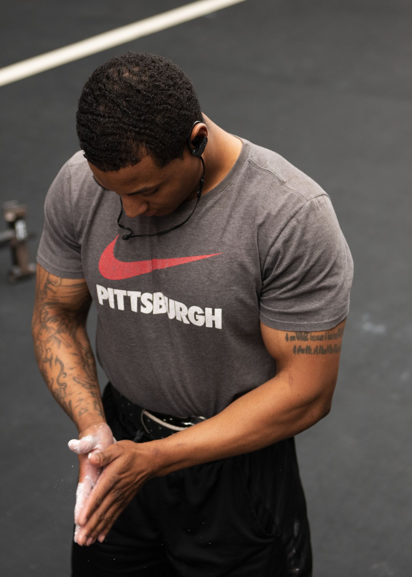 Airman 1st Class Jeremy Conway, 63rd Operation Support Squadron aircrew flight equipment member, spreads chalk on his hands in preparation for a deadlift during the Luke Powerlifting Competition, May 17, 2019, at Luke Air Force Base, Ariz.