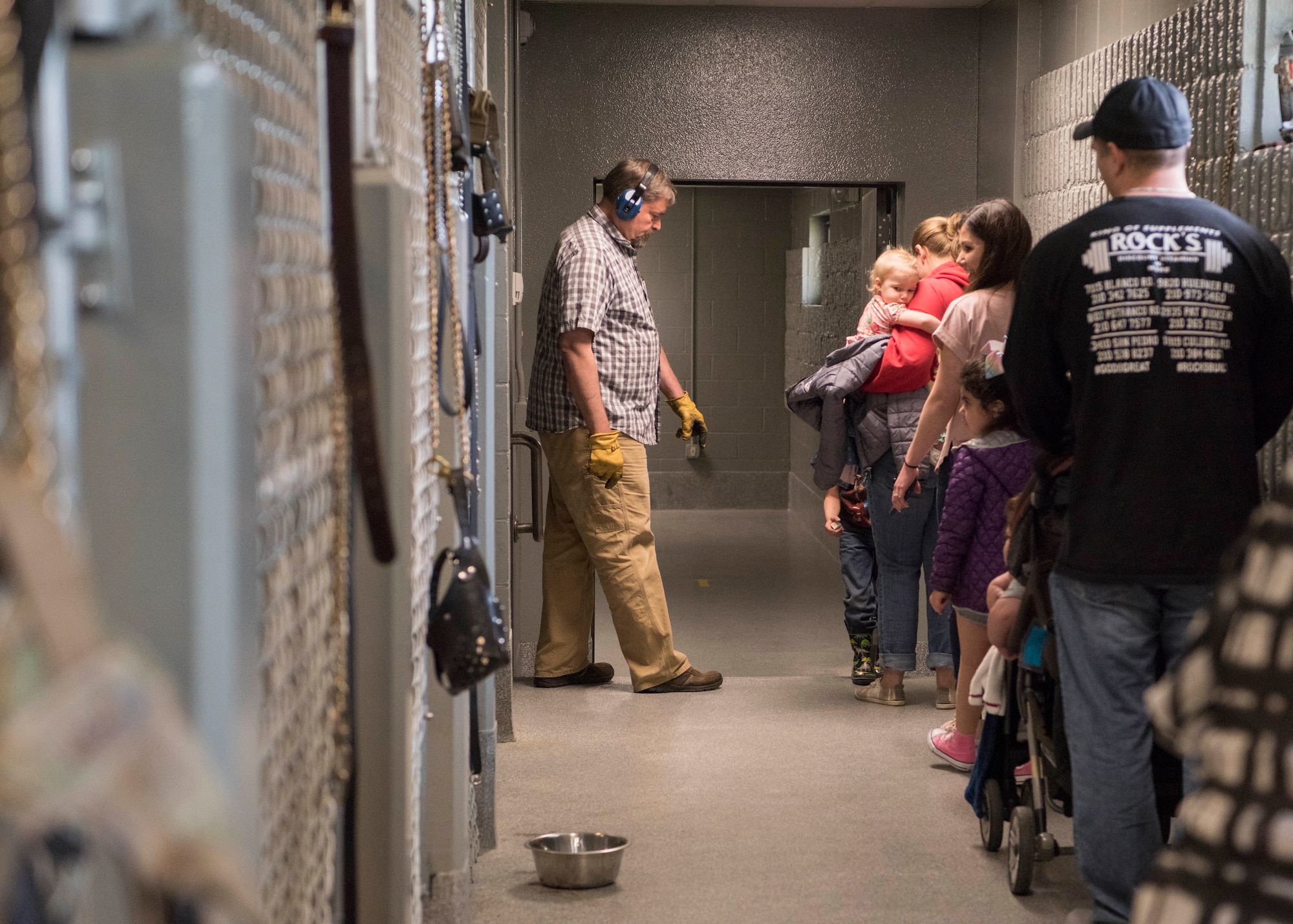 Family members of the 673d Security Forces Squadron visit the Military Working Dog facilities at Joint Base Elmendorf-Richardson, Alaska, May 16, 2019. In commemoration of Police Week, multiple demonstrations and activities were organized to highlight defender-style training and work conduct which included a defender family day tour.