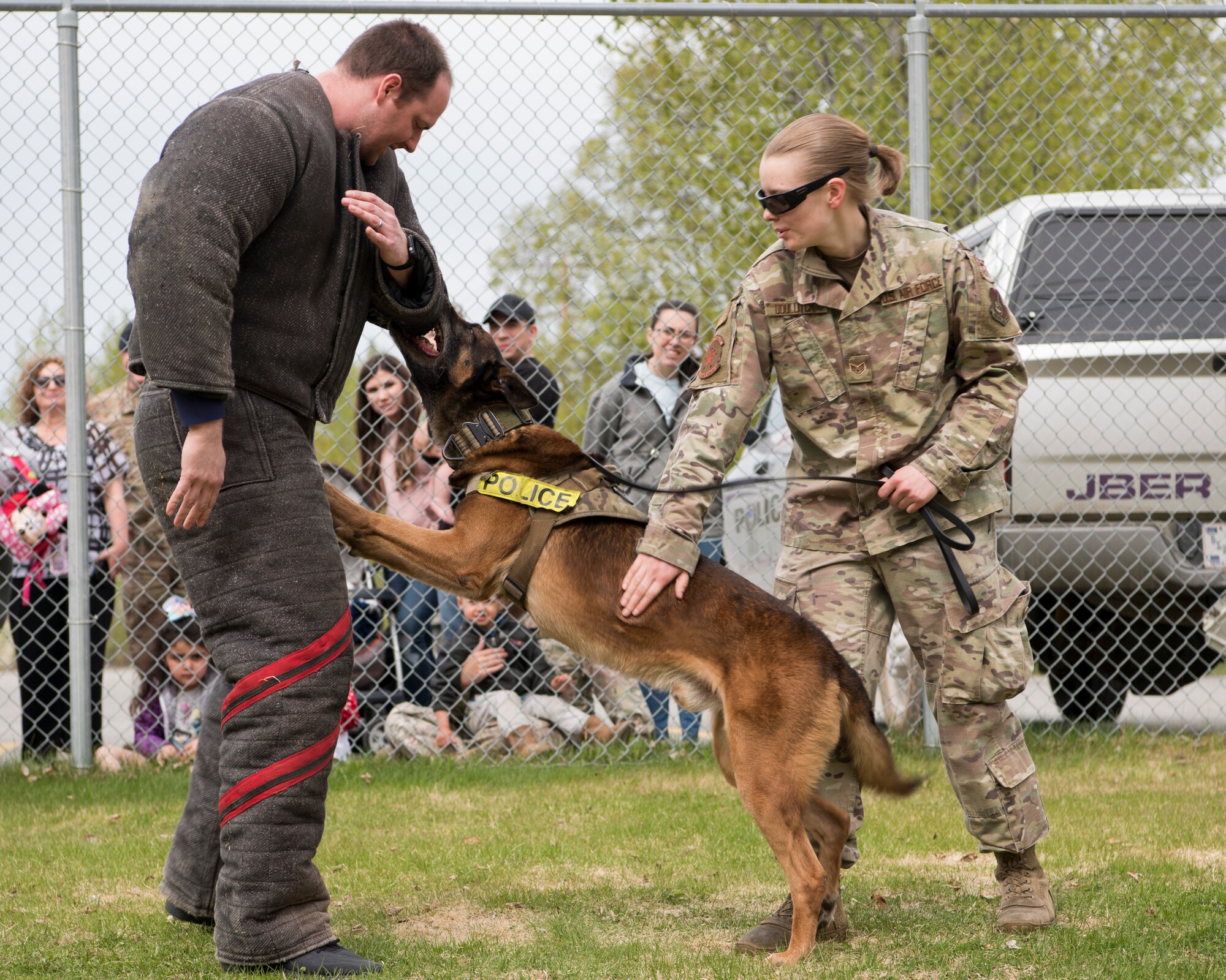 U.S. Air Force Staff Sgt. Melissa Udulutch, a 673d Security Forces Squadron Military Working Dog handler and MWD Chase, provide a demonstration at Joint Base Elmendorf-Richardson, Alaska, May 16, 2019. In commemoration of Police Week, multiple demonstrations and activities were organized to highlight defender-style training and work conduct which included a defender family day tour.