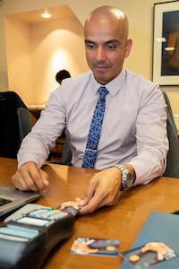 U.S. Marine Chief Warrant Officer Timothy Taylor, Regional Disbursing Office West expeditionary fiscal officer, trains on a point-of-sale device used to process EagleCash payments during a U.S. Army Financial Management Command and Federal Reserve Bank of Boston-hosted training session at the Federal Reserve Bank of Boston May 8, 2019.